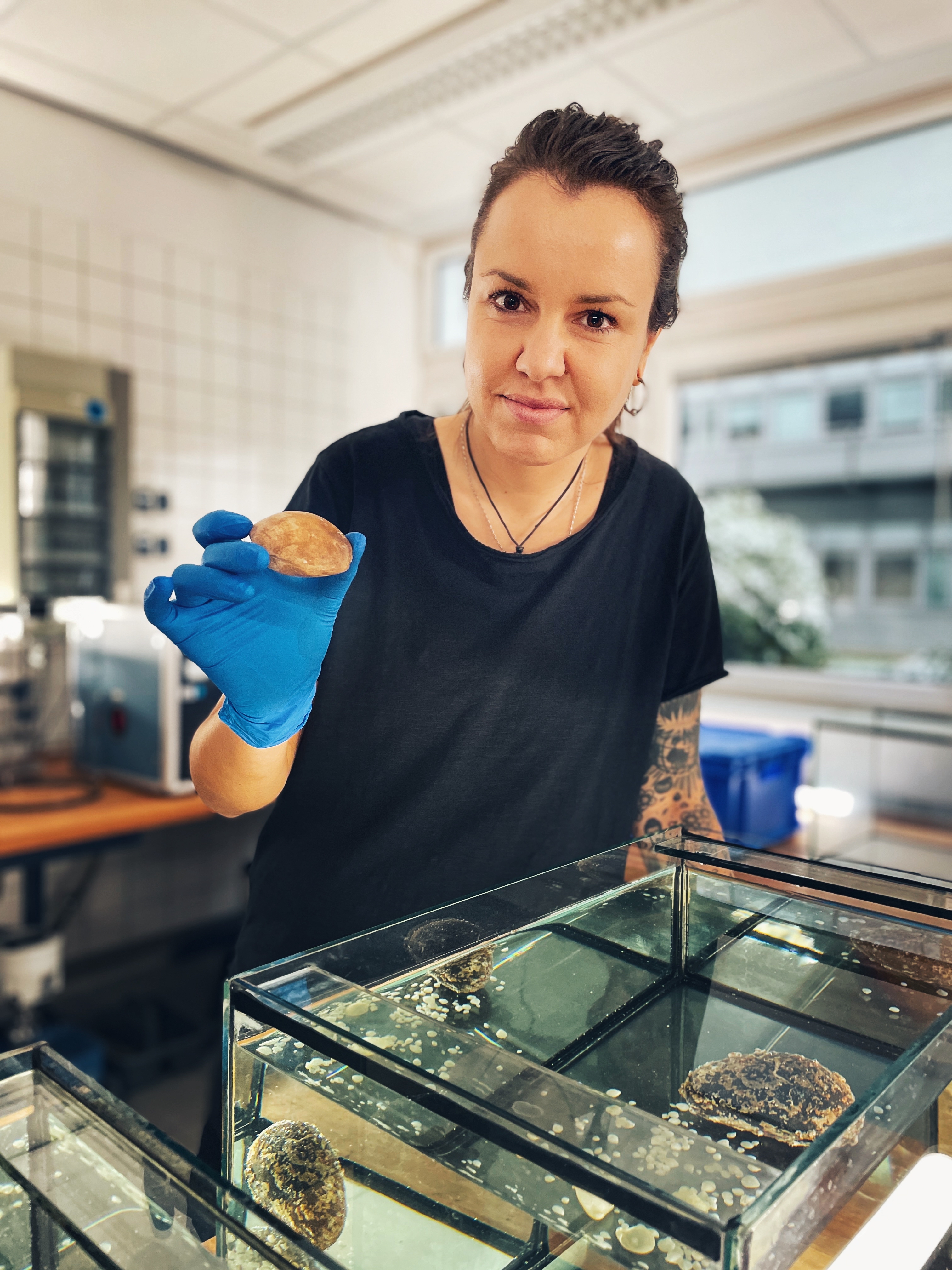 Dr Hana Jurikova displays a brachiopod specimen. Photo © Stefan Göppert, ZDF